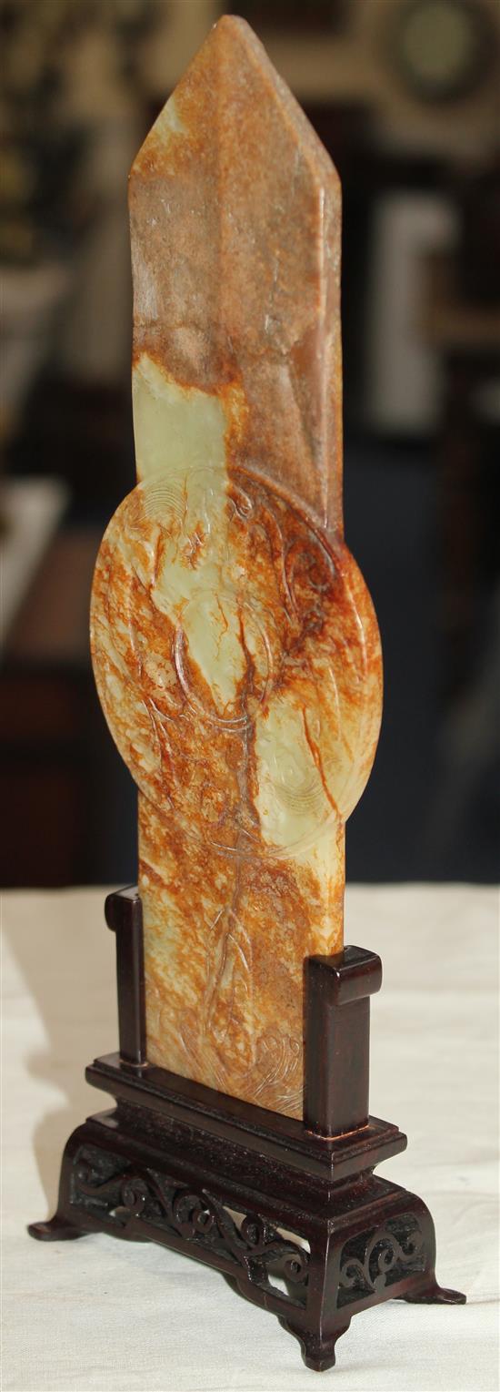 A Chinese yellow and russet jade tablet (gui), Ming dynasty or later, 19.1cm, broken and restored at pointed end, wood stand.